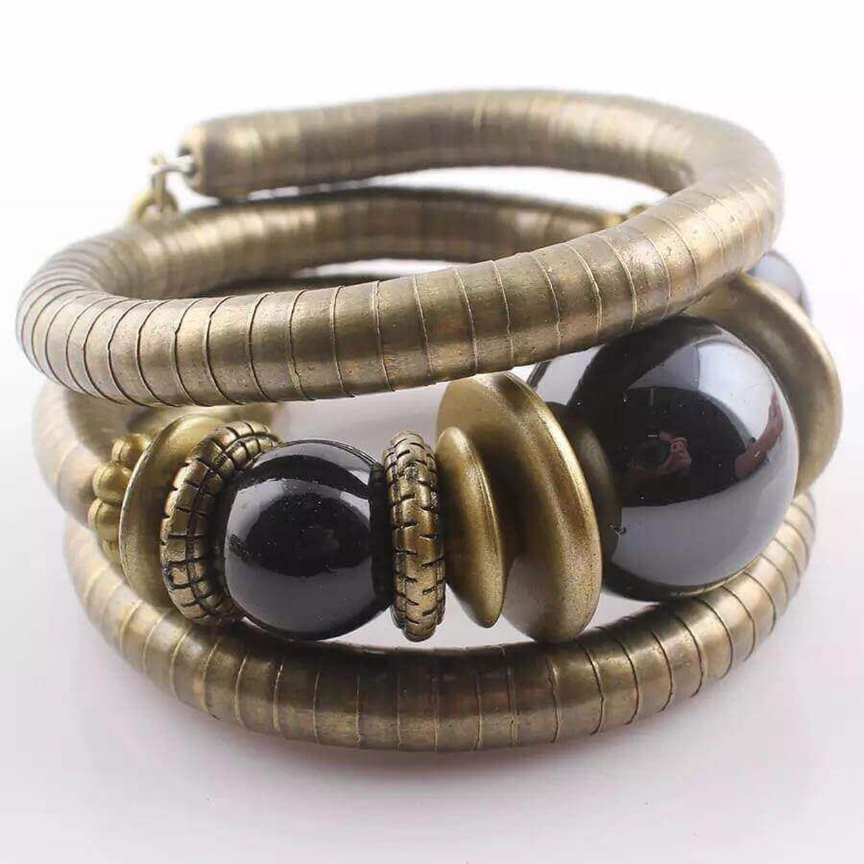 Angled view of the Midnight Eclipse Coil Bracelet showcasing antique bronze coil design with glossy black beads.