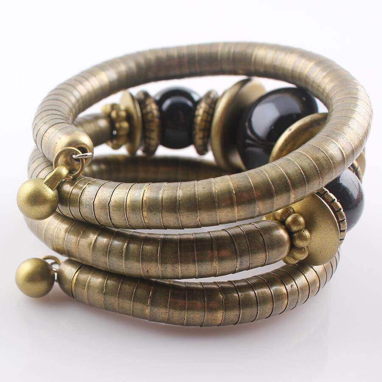 Back view of the Midnight Eclipse Coil Bracelet displaying its flexible antique bronze coil construction and clasp detail.