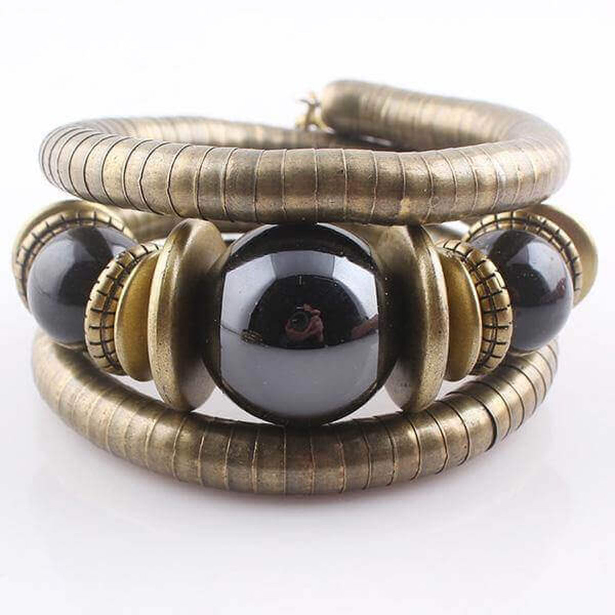 Front view of the Midnight Eclipse Coil Bracelet featuring antique bronze coils with polished black statement beads.
