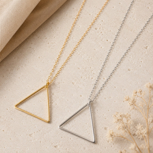 Minimalist Triangle Pendant Necklace available in gold and silver with modern open triangle geometric pendant.