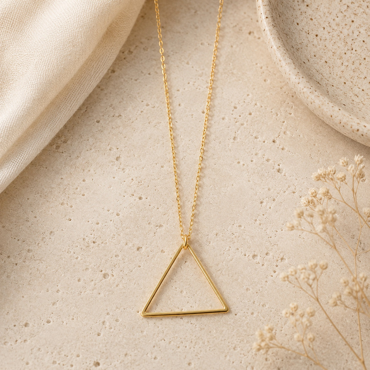 Gold Minimalist Triangle Pendant Necklace with sleek geometric open triangle design on a delicate chain.