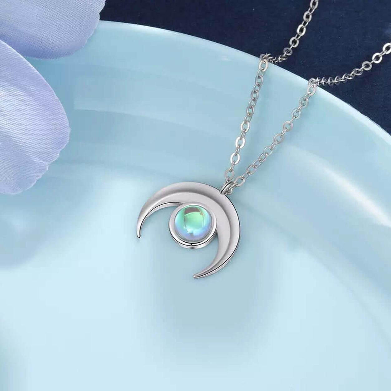 Close-up of the Moonstone Crescent Pendant Necklace featuring a glowing moonstone set in a sterling silver crescent.