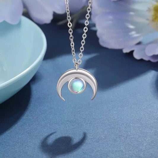 Moonstone Crescent Pendant Necklace in sterling silver with luminous moonstone pendant hanging on chain.