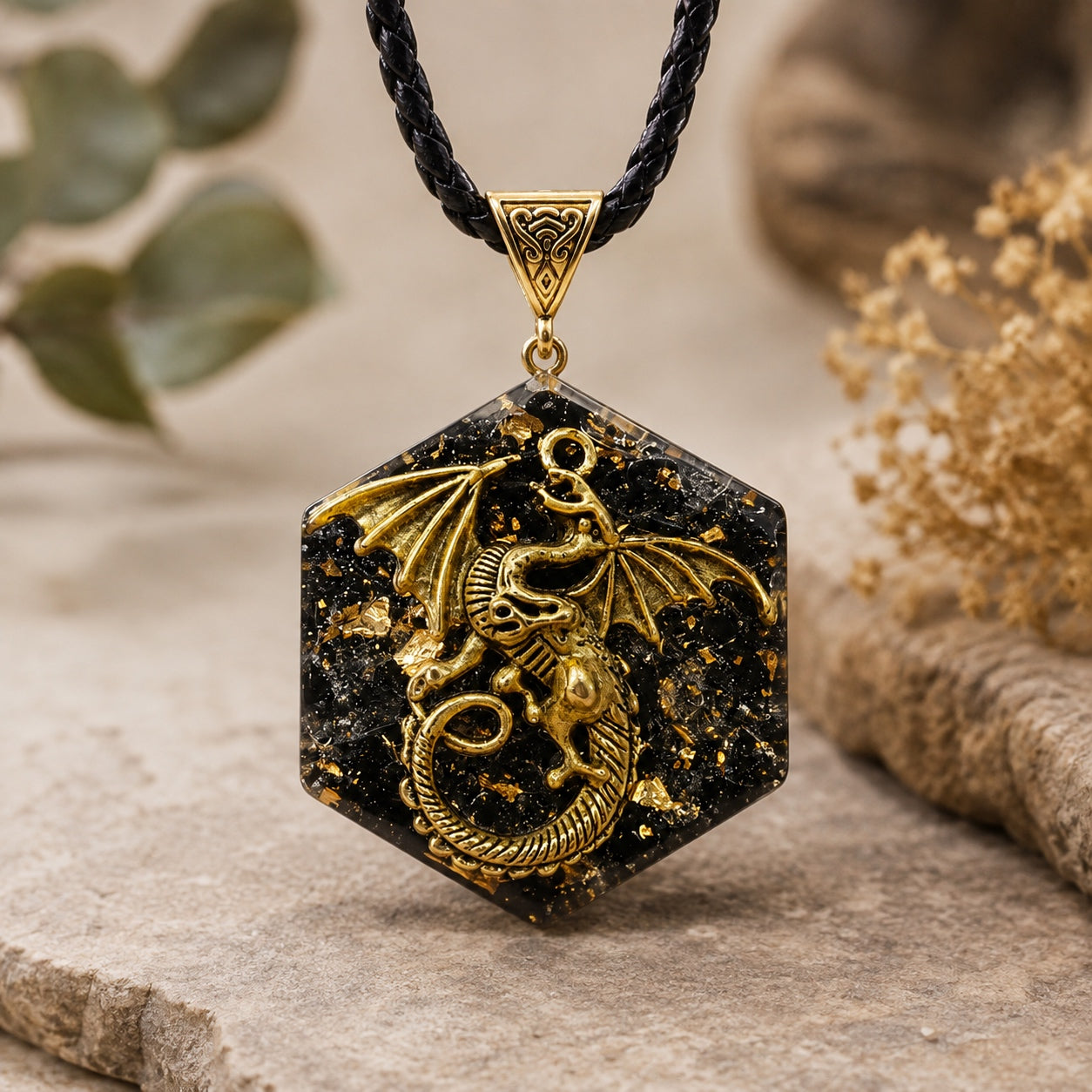 Obsidian Dragon Pendant Necklace featuring a gold dragon set in a black obsidian crystal hexagon pendant on a braided black cord.