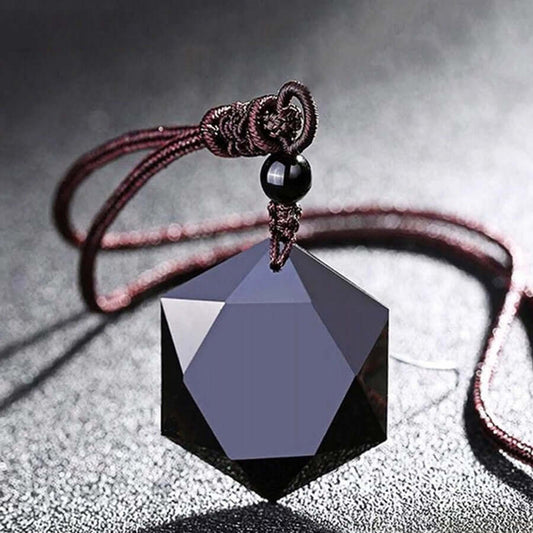 Obsidian Hexagon Pendant Necklace with faceted black gemstone on an adjustable brown cord in a close-up jewelry display.