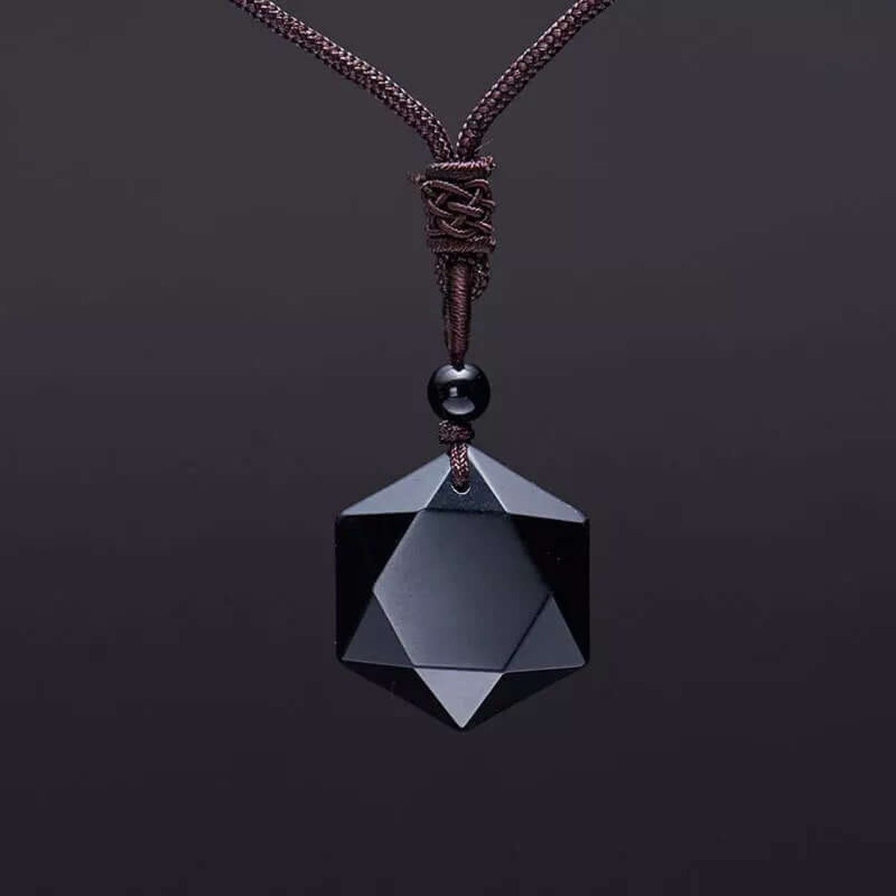Front view of the Obsidian Hexagon Pendant Necklace featuring a polished faceted black obsidian crystal pendant on a braided cord.