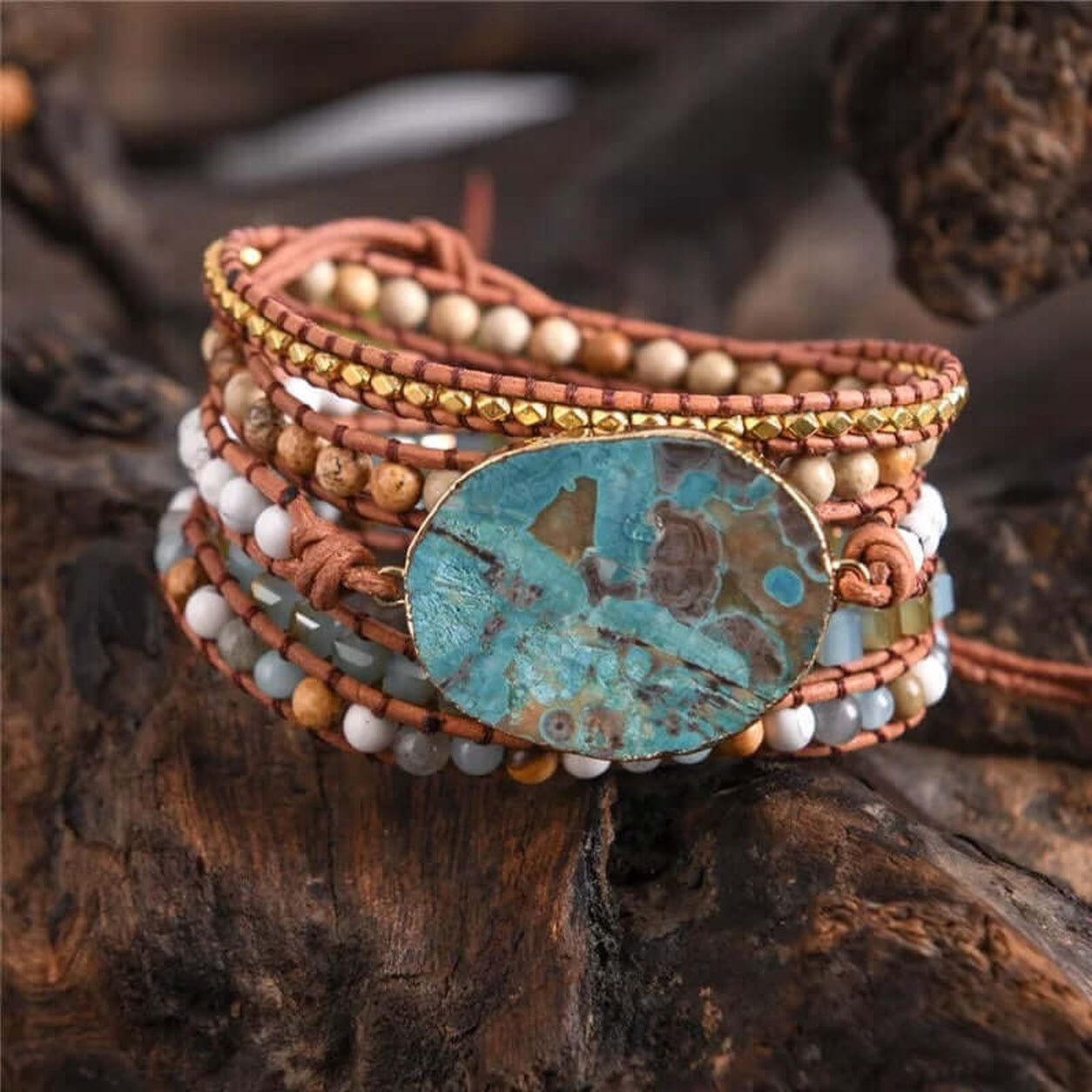 Ocean Jasper Wrap Bracelet displayed on rustic wood, showcasing genuine ocean jasper, leather cord, natural stone beads, and gold-tone accents.