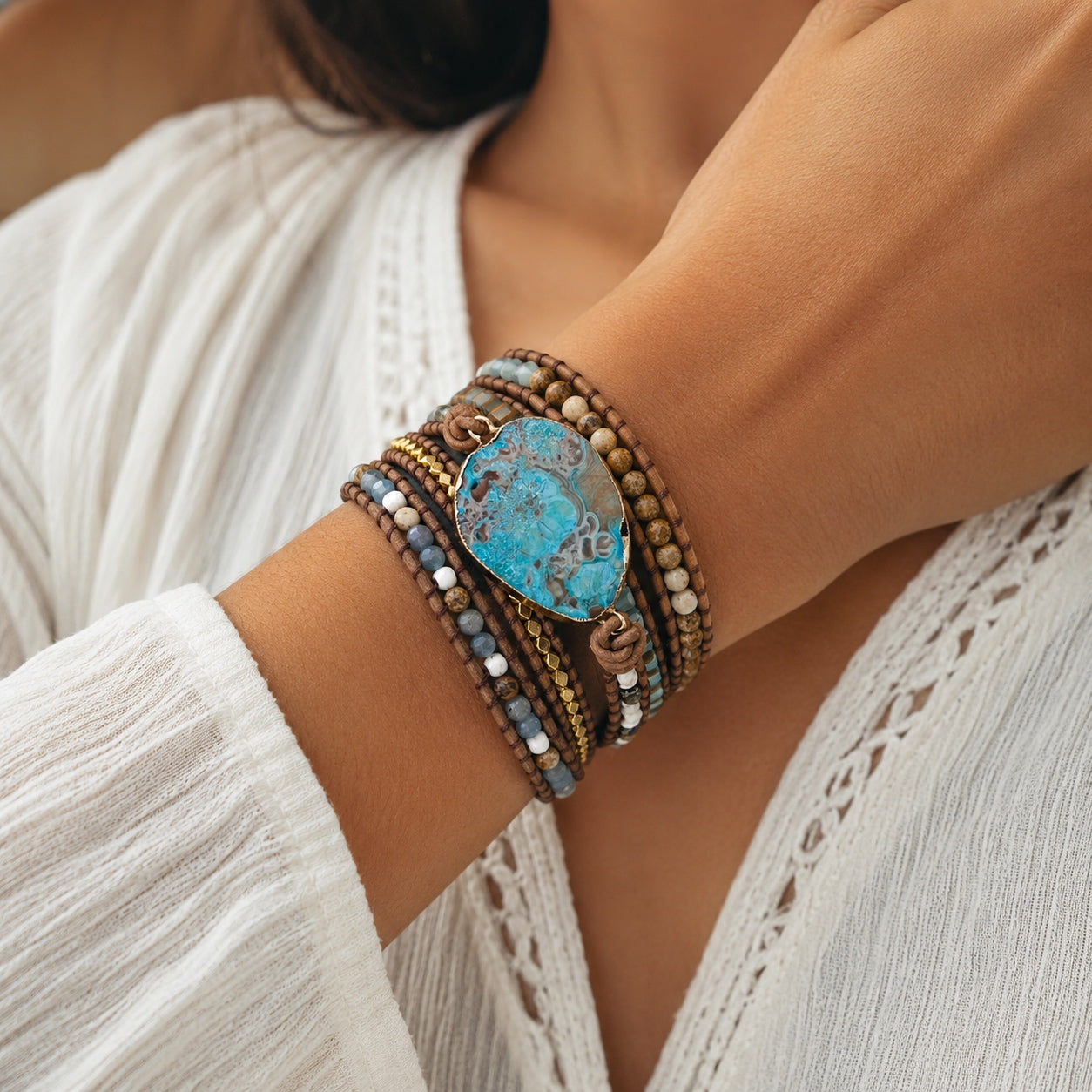 Woman wearing the Ocean Jasper Wrap Bracelet with natural ocean jasper gemstone, leather wrap, and earthy boho-inspired beadwork.