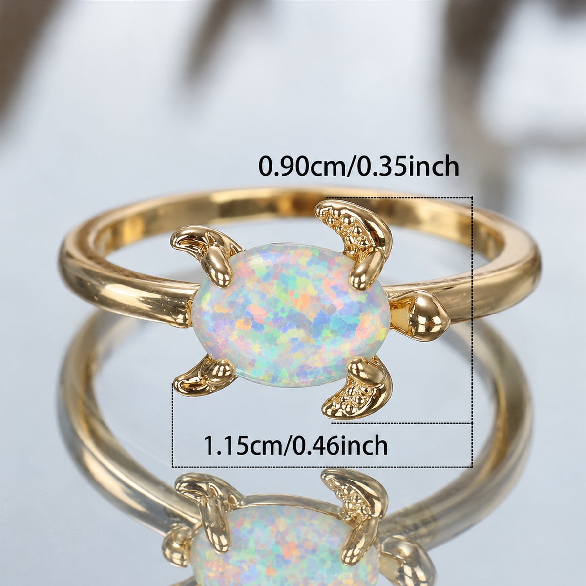 Gold turtle-shaped ring with an iridescent white opal center, shown with overlaid dimension labels reading 0.90cm/0.