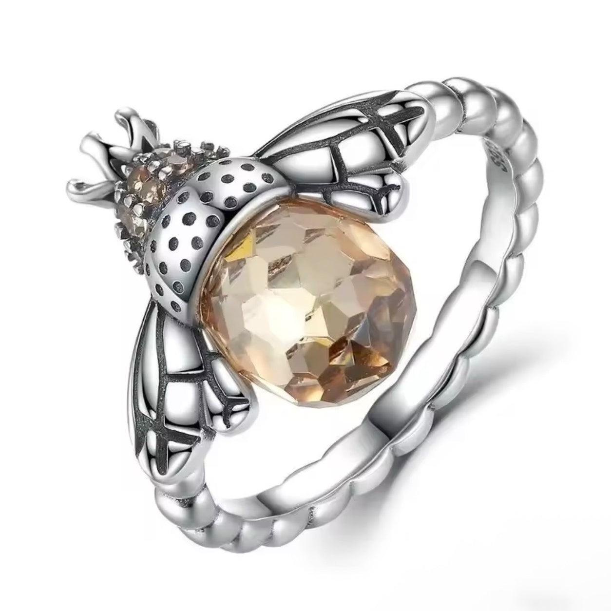 Close-up of Queen Bee Ring with detailed silver bee wings, crystal accents and faceted honey-colored stone.