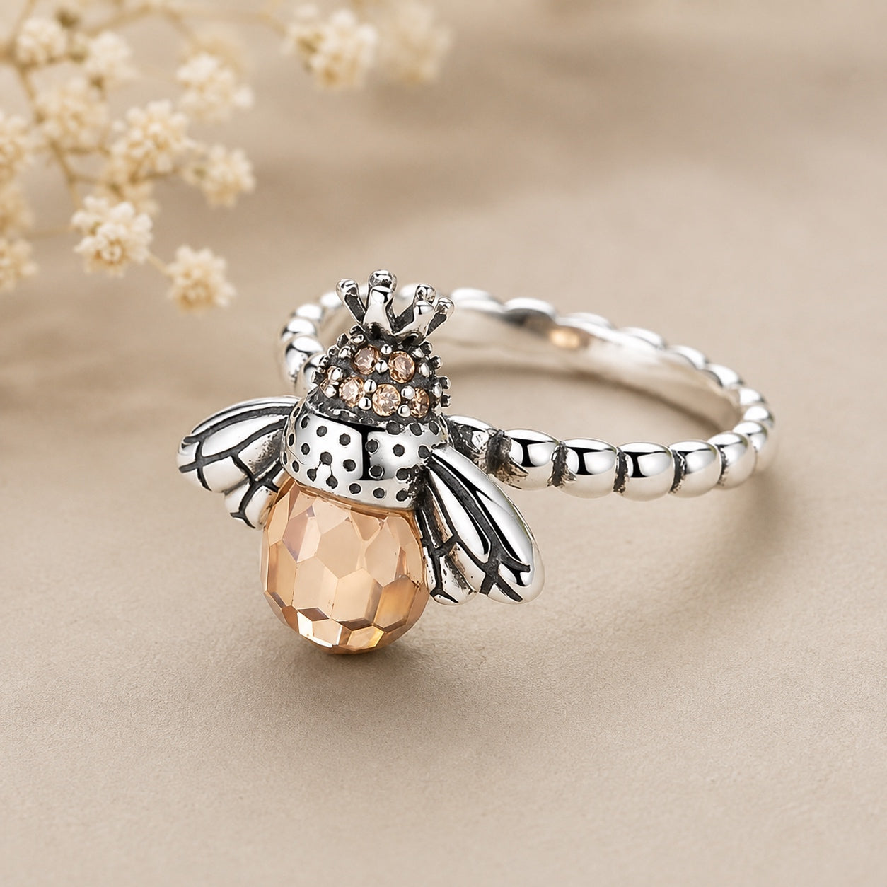 Queen Bee Ring in silver with faceted honey-colored bee and crystal details.