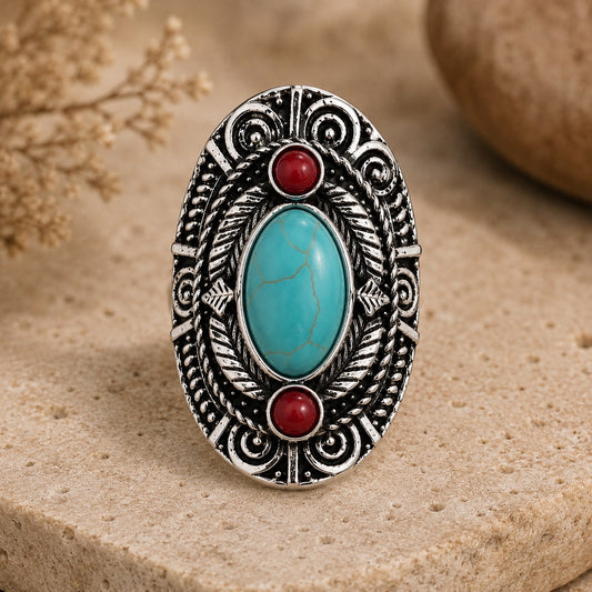 Red Jasper Turquoise Tribal Ring with silver tribal detailing displayed on a natural stone surface.