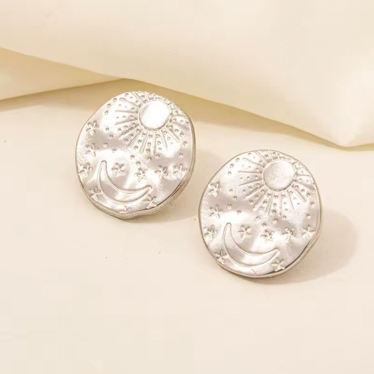 Silver Celestial Stud Earrings with embossed sun, crescent moon and star design.