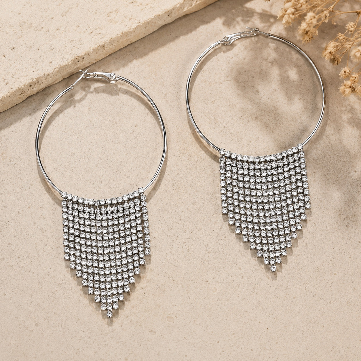 Silver Crystal Fringe Hoop Earrings with sparkling rhinestone tassels displayed on a neutral background.