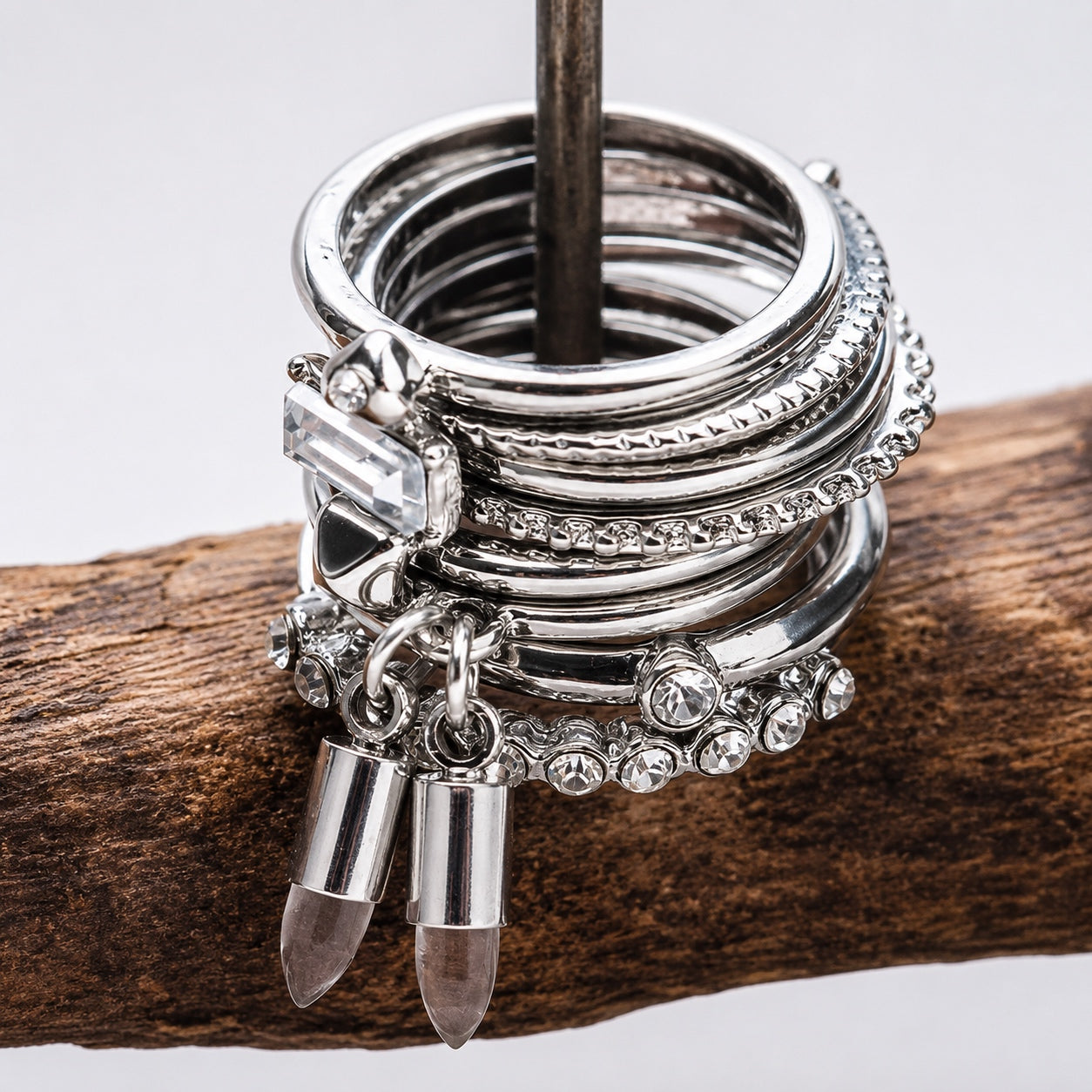 Silver Stacking Ring Set displayed on a wooden jewelry stand showing crystal, rhinestone and natural stone charm rings.
