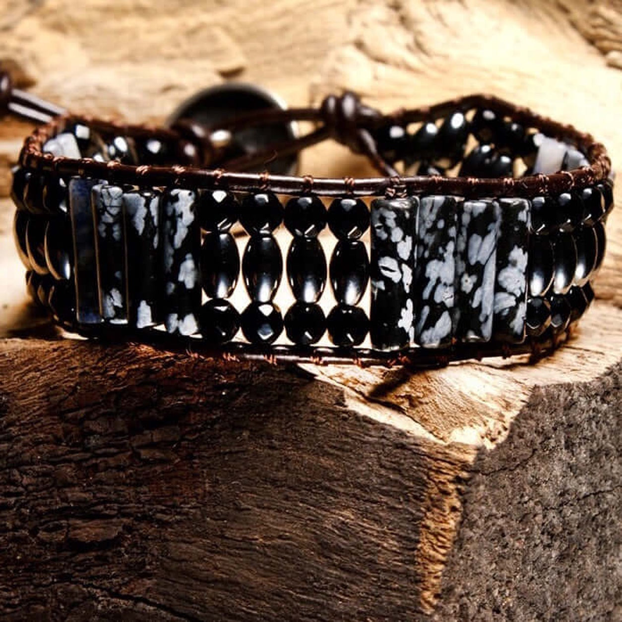 Snowflake Obsidian Bracelet photographed on rustic wood, showcasing natural snowflake obsidian gemstones.