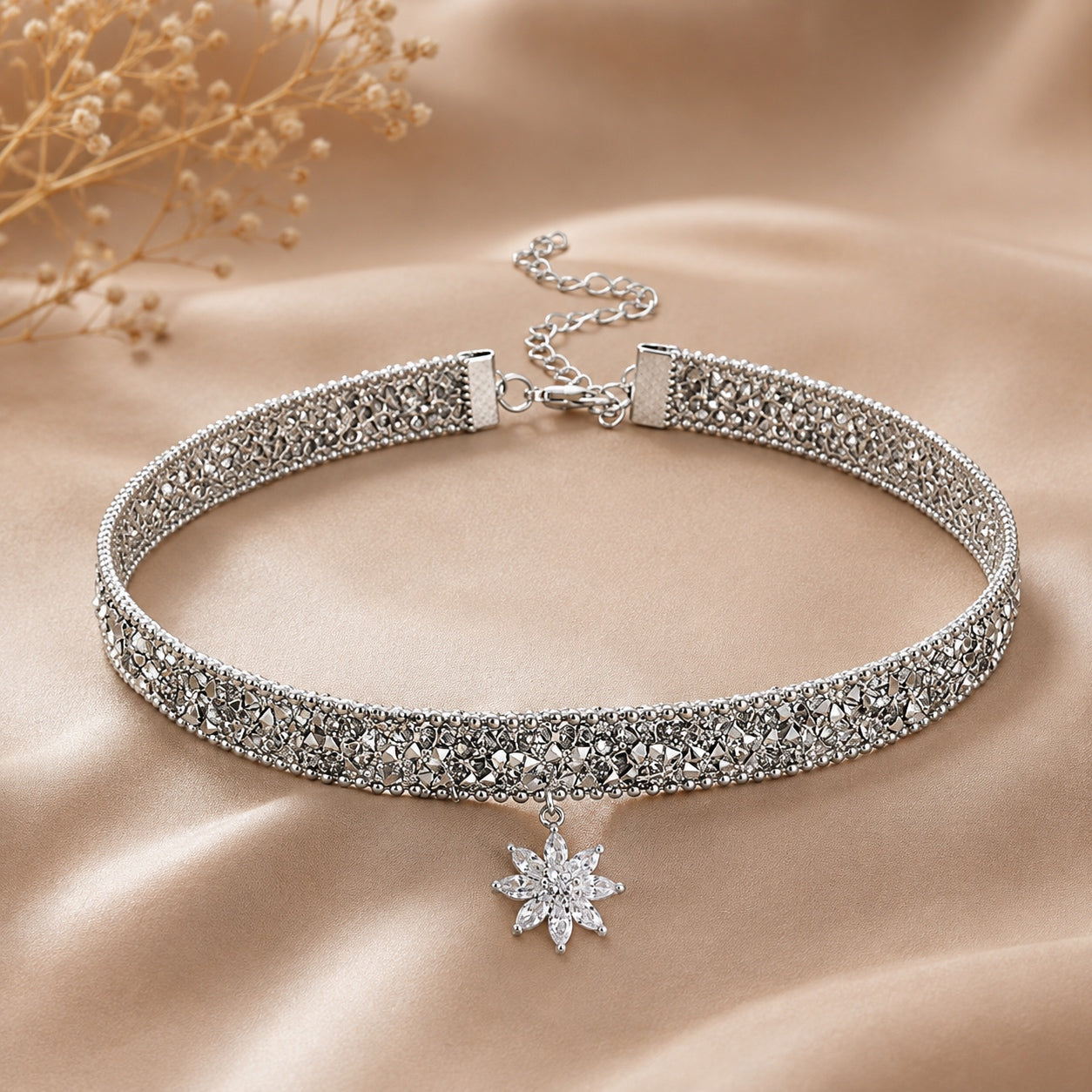 Sparkle Flower Choker Necklace displayed on champagne satin with a crystal flower pendant and shimmering silver choker.
