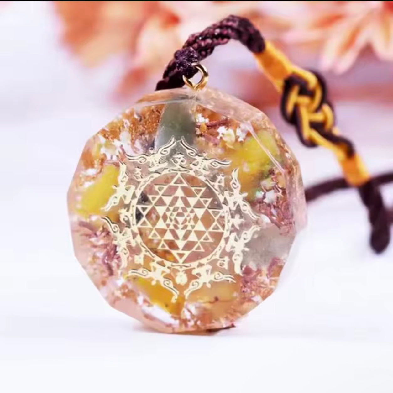 Close angled view of the Sri Yantra Topaz Pendant Necklace with topaz, green aventurine and handcrafted orgonite pendant.
