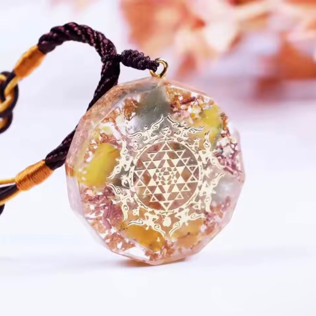 Angled view of the Sri Yantra Topaz Pendant Necklace featuring genuine gemstones, copper flakes and sacred Sri Yantra design.
