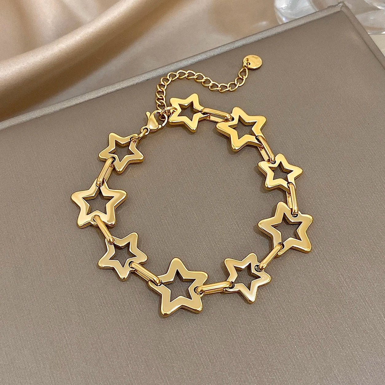 Gold Star Link Chain Bracelet featuring polished hollow star links with an adjustable chain.