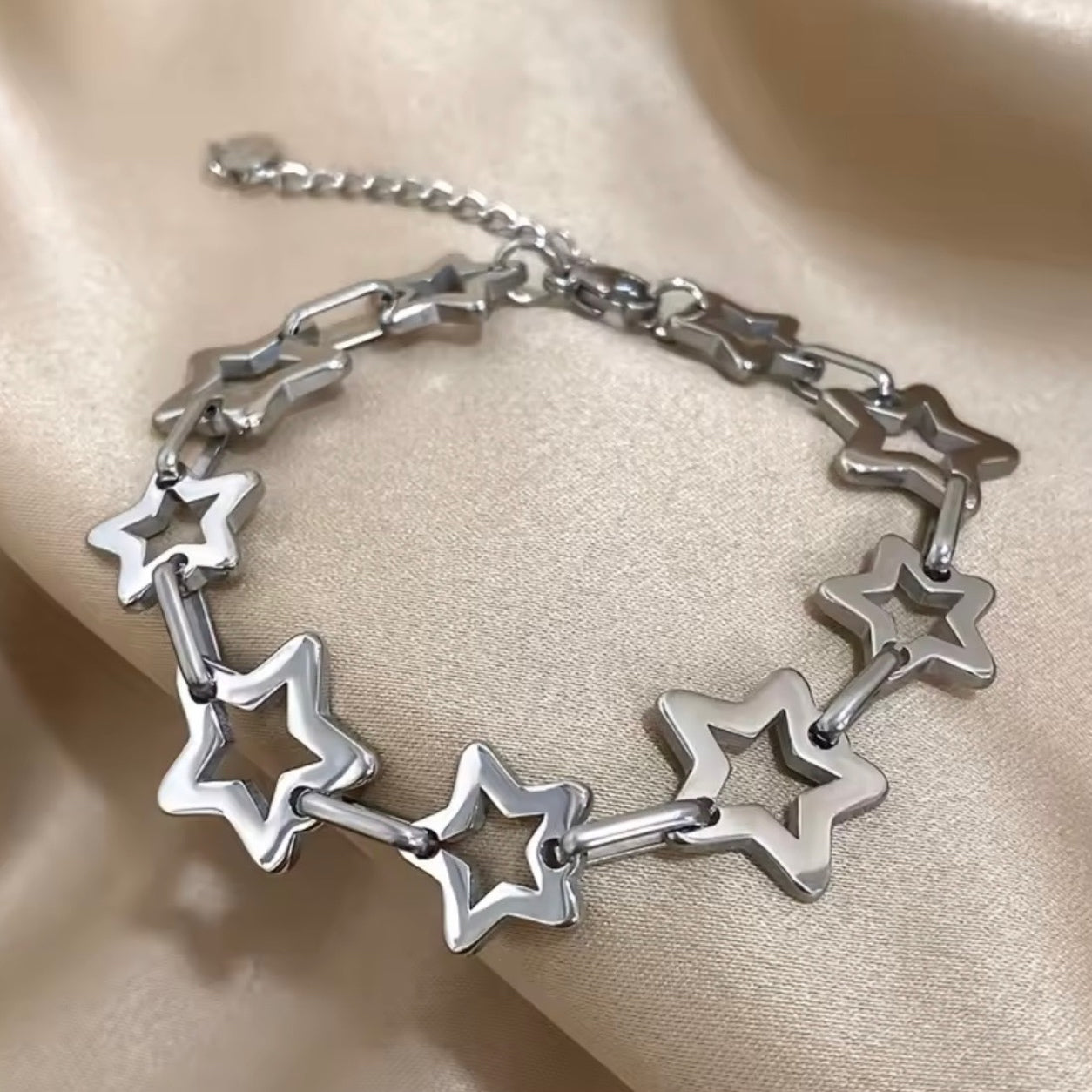 Close-up of the silver Star Link Chain Bracelet with polished hollow star links and adjustable chain.