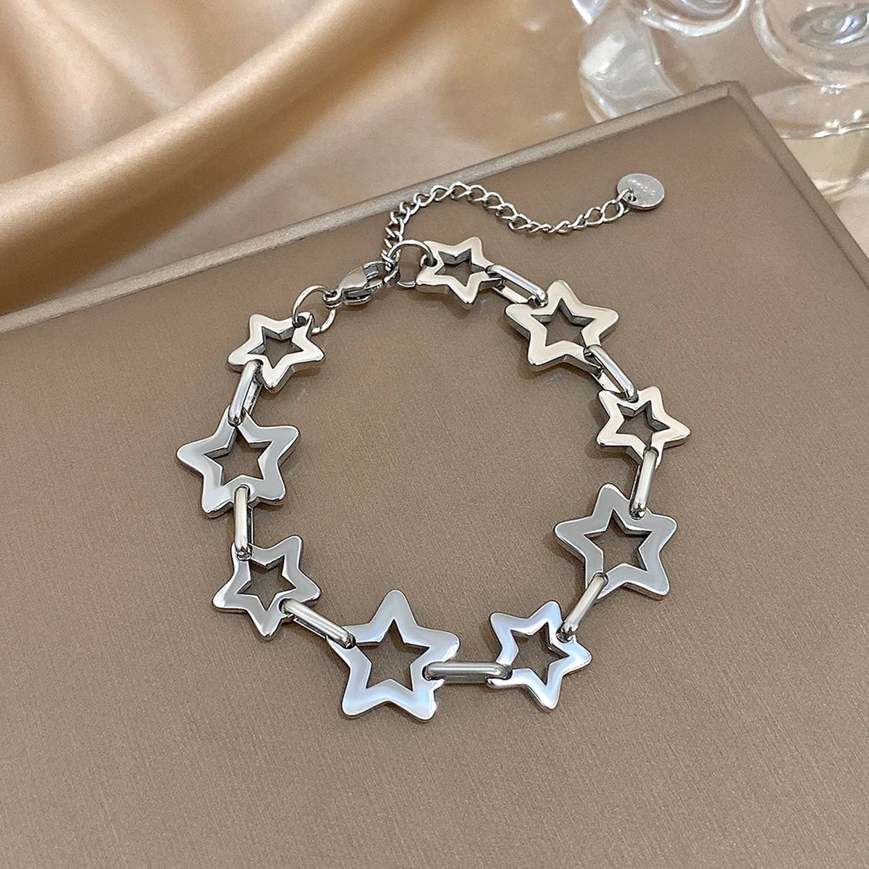 Silver Star Link Chain Bracelet with polished hollow star links and an adjustable extension chain.