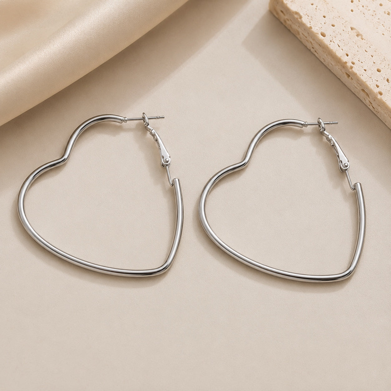 Timeless Heart Hoop Earrings in silver, heart-shaped hoop earrings on a neutral background.