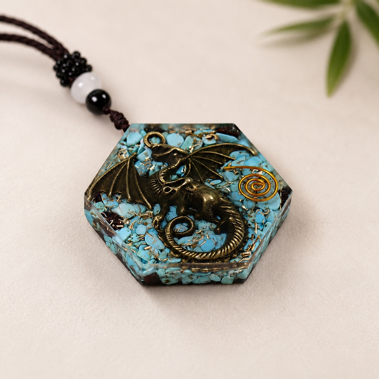 Close-up of a Turquoise Dragon Pendant Necklace with bronze dragon, turquoise stones, copper spiral, and resin hexagon pendant.
