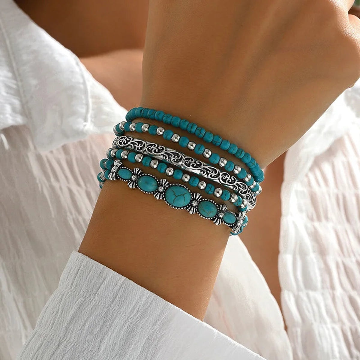 Boho turquoise bracelet stack featuring detailed silver-tone accents and oval turquoise-colored stones