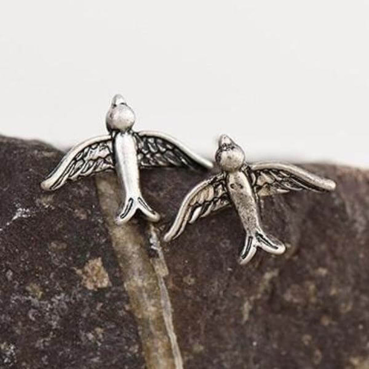Pair of Vintage Silver Bird Stud Earrings featuring flying bird design on natural stone.