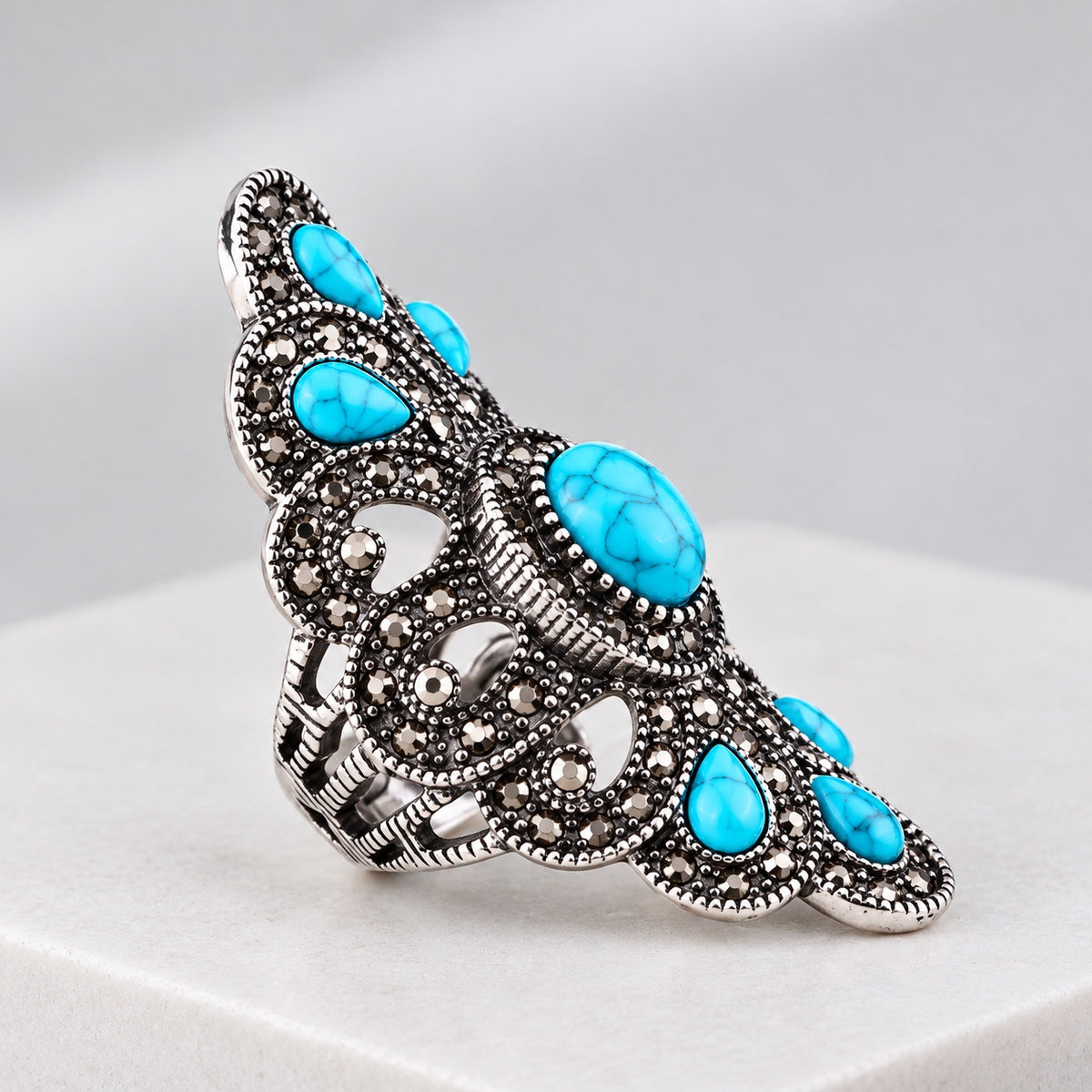 Side view vintage turquoise statement ring with antique silver, gray crystal accents and turquoise stones.