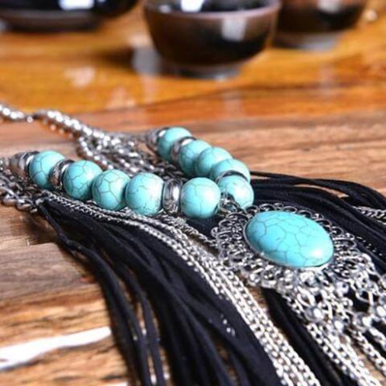 Close-up of the Western Turquoise Fringe Necklace highlighting turquoise beads, silver pendant and flowing black fringe details.