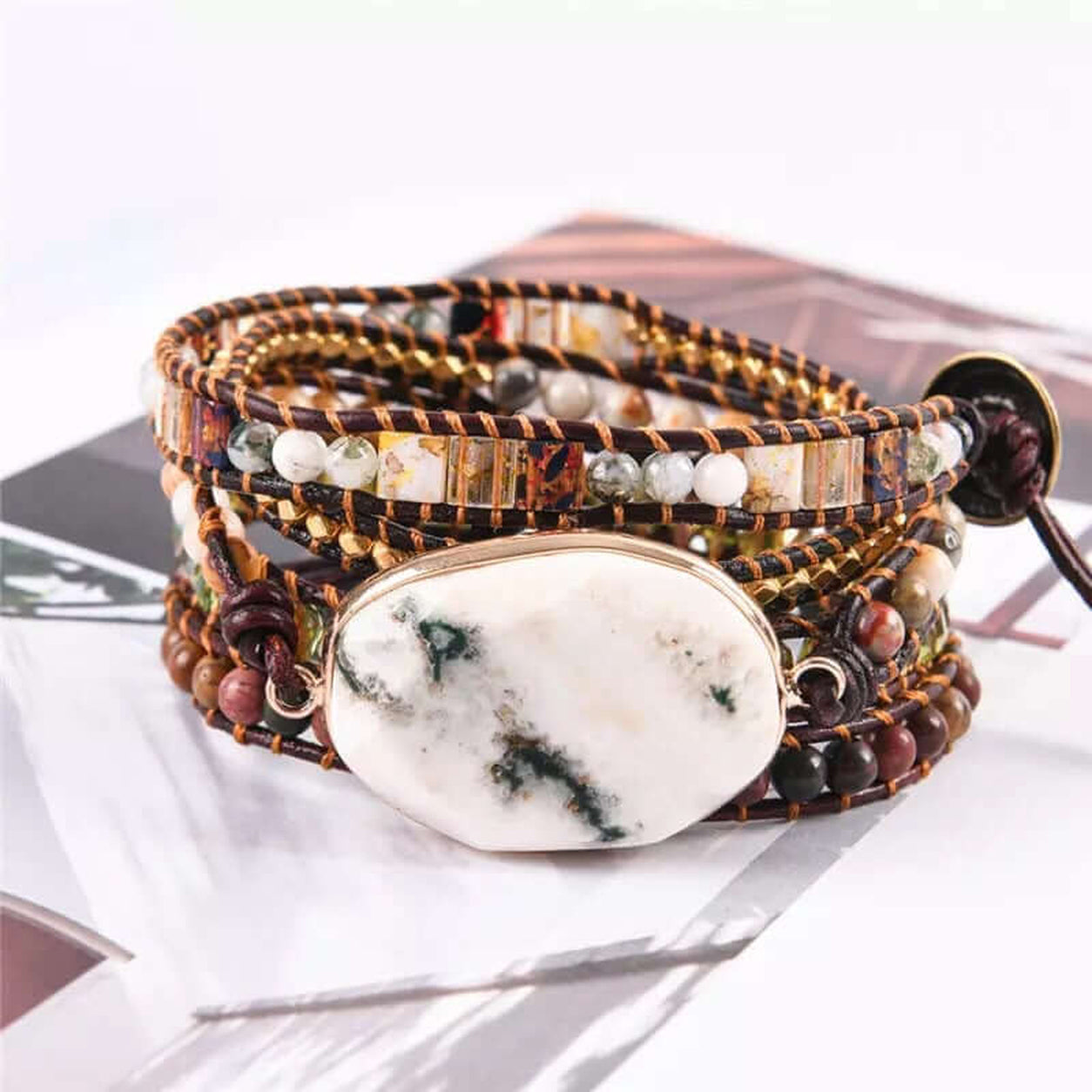 Angled view of the White Marble Stone Wrap Bracelet with natural white marble centerpiece, leather wrap, crystal beads, and gemstone accents.