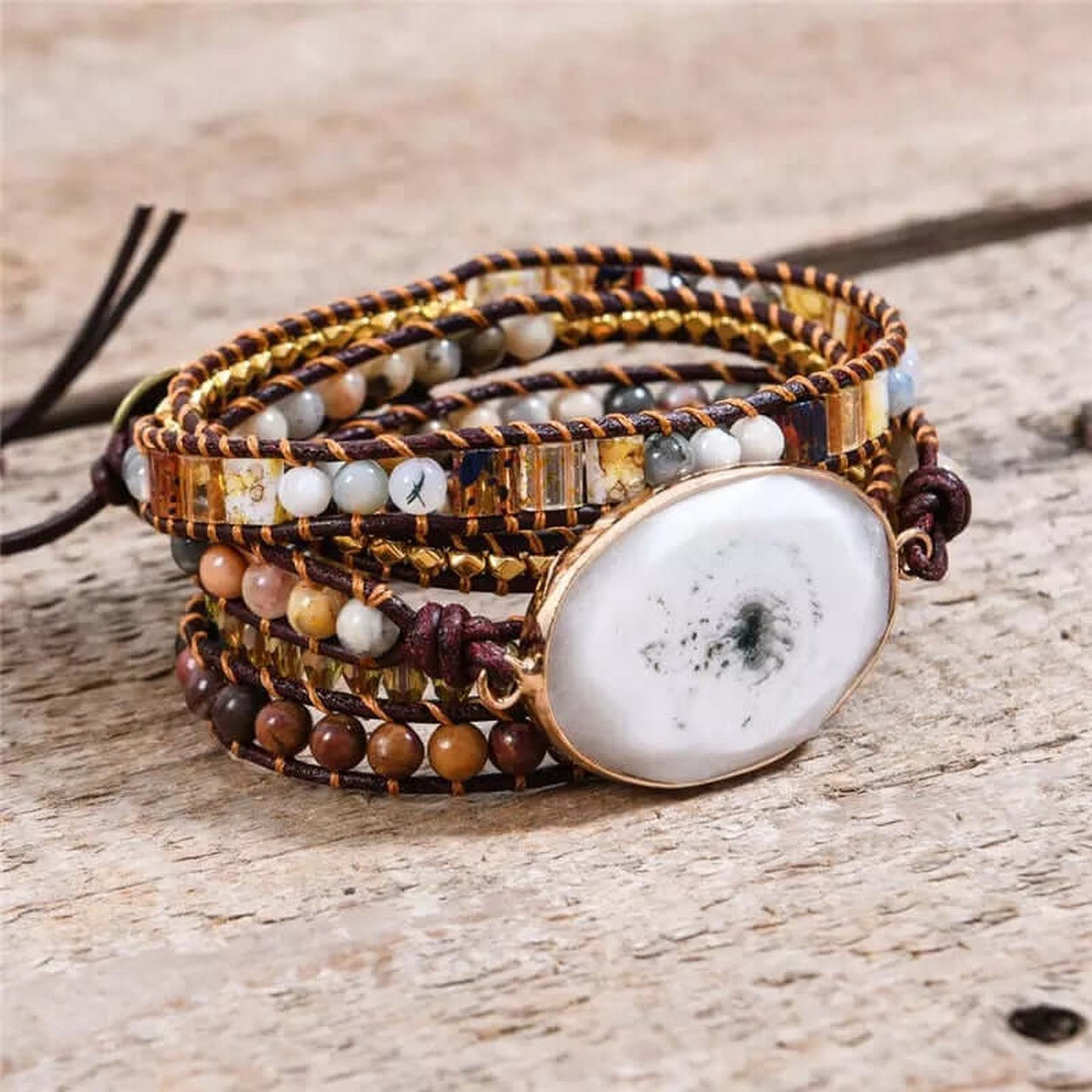 White Marble Stone Wrap Bracelet displayed on rustic wood showing genuine stone centerpiece, leather cord wrap, and natural beaded details.