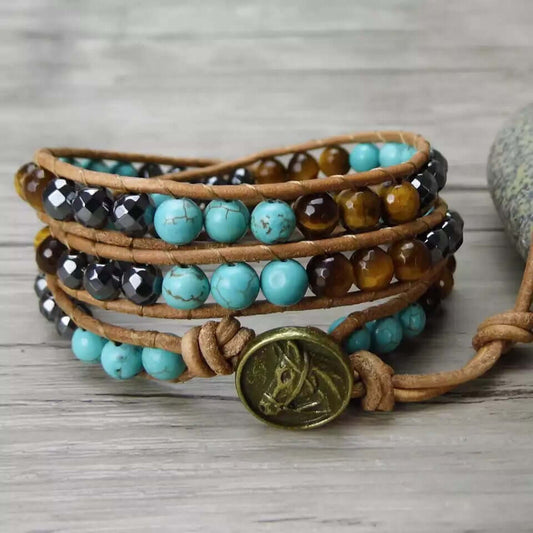 Spirit Of The West Bracelet featuring turquoise, tiger eye and faceted hematite beads handwoven on genuine leather with button clasp.